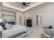 Spacious main bedroom with a neutral palette, tray ceilings, and a comfortable seating area at 2317 N Steele Cir, Mesa, AZ 85207