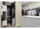 Walk-in closet features custom closet organizers and a central dresser at 315 S Racine Ct, Gilbert, AZ 85296