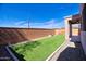 Enjoy a private outdoor space with artificial turf, enclosed by a brick wall and featuring a covered patio at 35210 N 34Th Ln, Phoenix, AZ 85086