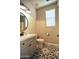 Stylish bathroom with modern vanity, round mirror, and patterned tile flooring at 35210 N 34Th Ln, Phoenix, AZ 85086