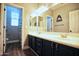 Bathroom featuring double sinks, wood-look flooring, and tub/shower creates a stylish and functional space at 35210 N 34Th Ln, Phoenix, AZ 85086