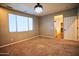 Spacious bedroom featuring plush carpet, large windows, and a stylish chandelier at 35210 N 34Th Ln, Phoenix, AZ 85086