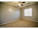 Bedroom with carpet flooring, ceiling fan, and window offers comfort and natural lighting, a cozy retreat at 35210 N 34Th Ln, Phoenix, AZ 85086