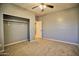 Bedroom with carpet flooring, ceiling fan, and closet provides comfort and ample storage space, a calming retreat at 35210 N 34Th Ln, Phoenix, AZ 85086