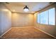 Bonus room featuring a modern chandelier, carpet flooring, and lots of natural light creates a luxurious feel at 35210 N 34Th Ln, Phoenix, AZ 85086