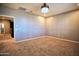 Bonus room featuring carpet flooring and a modern chandelier provides both style and functionality at 35210 N 34Th Ln, Phoenix, AZ 85086