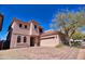 A beautiful two-story home featuring a brick driveway and an attached garage at 35210 N 34Th Ln, Phoenix, AZ 85086