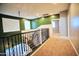 Upstairs hallway boasting carpet flooring, decorative railing, and natural light creates an inviting atmosphere at 35210 N 34Th Ln, Phoenix, AZ 85086