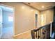 Upstairs hallway with neutral walls, carpeted floors, and access to several rooms at 35210 N 34Th Ln, Phoenix, AZ 85086