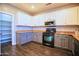 Kitchen with granite countertops, stainless steel microwave, and grey lower cabinets at 35210 N 34Th Ln, Phoenix, AZ 85086