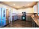 Kitchen with stainless steel refrigerator, granite countertops, and grey lower cabinets at 35210 N 34Th Ln, Phoenix, AZ 85086