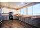 Kitchen features stainless steel appliances, granite countertops, and two-toned cabinets at 35210 N 34Th Ln, Phoenix, AZ 85086