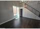 Bright living room boasts high ceilings, dark wood floors, and modern staircase with beautiful metal railings at 35210 N 34Th Ln, Phoenix, AZ 85086
