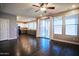 Open-concept living room and kitchen with hardwood floors and a sliding glass door to the backyard at 35210 N 34Th Ln, Phoenix, AZ 85086