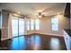 Open living area with sliding glass doors, large windows, and sleek ceiling fan at 35210 N 34Th Ln, Phoenix, AZ 85086