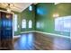 A spacious room with green walls, arched windows, and stylish light fixtures at 35210 N 34Th Ln, Phoenix, AZ 85086