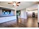 Open-concept living room and kitchen featuring hardwood floors, stairs and built-in entertainment center at 35210 N 34Th Ln, Phoenix, AZ 85086