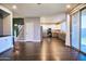 Open concept living room with hardwood floors, staircase, and kitchen with stainless steel appliances at 35210 N 34Th Ln, Phoenix, AZ 85086