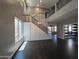 Bright living room boasts high ceilings, dark wood floors, and modern staircase with beautiful metal railings at 35210 N 34Th Ln, Phoenix, AZ 85086