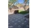 Backyard with stone pavers, artificial turf, a built-in grill, and a neutral-toned block wall at 3556 E Ivanhoe St, Gilbert, AZ 85295