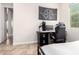 Neutral bedroom featuring a dark computer desk and black and white banner on wall at 3556 E Ivanhoe St, Gilbert, AZ 85295