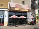 Exterior view of a 'Salt & Straw' ice cream shop, featuring outdoor seating with striped umbrellas at 3556 E Ivanhoe St, Gilbert, AZ 85295