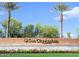 Sun City Anthem signage with well maintained landscape and beautiful palm trees at 3751 N Hidden Canyon Dr, Florence, AZ 85132