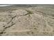Overhead angle showcasing desert landscape with sparse vegetation and winding dirt roads on a clear day at 385 W Vineyard Rd # C, Tonopah, AZ 85354