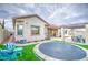 Spacious backyard with a trampoline, patio seating, and low-maintenance landscaping at 4207 S Electron --, Mesa, AZ 85212