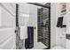 Sleek bathroom featuring a modern shower with black and white tiling and glass door at 4207 S Electron --, Mesa, AZ 85212