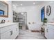 Well-lit bathroom showcasing dual vanities, soaking tub, glass-enclosed shower, and modern finishes at 4207 S Electron --, Mesa, AZ 85212