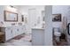 Bright bathroom with a dual vanity, quartz countertops, and wood-look tile flooring at 4207 S Electron --, Mesa, AZ 85212