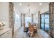 Elegant dining room with a long table, wicker chairs, stylish curtains, and ample natural light at 4207 S Electron --, Mesa, AZ 85212