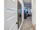 Hallway with a large decorative mirror leading to a room with exercise equipment and natural light at 4207 S Electron --, Mesa, AZ 85212