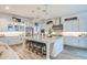 Modern kitchen with a large island, stainless steel appliances, granite countertops, and stylish pendant lights at 4207 S Electron --, Mesa, AZ 85212
