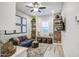 Inviting living room featuring a comfortable blue sofa, built-in shelves, patterned wallpaper and plenty of natural light at 4207 S Electron --, Mesa, AZ 85212