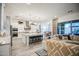 Open-concept living space with a modern kitchen, island seating, and a comfortable living room area at 4207 S Electron --, Mesa, AZ 85212
