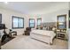 Bright main bedroom with an exercise area, plush bedding, and large windows with wood shutters at 4207 S Electron --, Mesa, AZ 85212