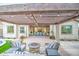 Relaxing outdoor living area with a pergola, comfortable seating, and a cozy fire pit at 4207 S Electron --, Mesa, AZ 85212