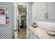 Convenient pantry featuring white cabinets, granite countertops, stylish backsplash and a walk-in storage area at 4207 S Electron --, Mesa, AZ 85212