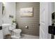 Stylish powder room with shiplap wall, pedestal sink, and decorative patterned floors at 4207 S Electron --, Mesa, AZ 85212