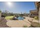 Backyard with a pool, putting green, and built-in grill perfect for outdoor entertaining at 4243 S Hackberry Trl, Gold Canyon, AZ 85118