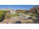 Expansive backyard featuring a pool, putting green, and outdoor seating area at 4243 S Hackberry Trl, Gold Canyon, AZ 85118