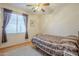 Cozy bedroom featuring a ceiling fan, window with blinds, and comfortable bed at 4243 S Hackberry Trl, Gold Canyon, AZ 85118