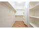 Spacious walk-in closet with shelving and wooden floor at 4243 S Hackberry Trl, Gold Canyon, AZ 85118
