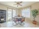 Bright dining area with sliding glass doors, tiled floors, and neutral paint, located adjacent to kitchen at 4243 S Hackberry Trl, Gold Canyon, AZ 85118