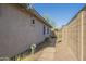 Exterior view of the side yard with gravel pathway, desert plants, and fence at 4243 S Hackberry Trl, Gold Canyon, AZ 85118
