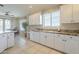 Spacious kitchen with white cabinets, granite counters, tiled floors, and a view to the adjacent dining area at 4243 S Hackberry Trl, Gold Canyon, AZ 85118
