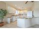 Bright kitchen featuring white cabinets, granite countertops, tiled floors, and a spacious central island at 4243 S Hackberry Trl, Gold Canyon, AZ 85118