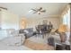 Well-lit living room featuring neutral decor, tile and laminate flooring, comfortable seating, and media center at 4243 S Hackberry Trl, Gold Canyon, AZ 85118